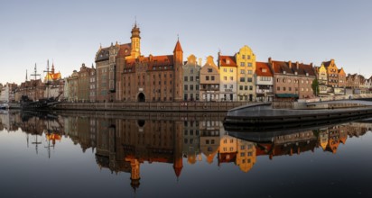 Panorama of the waterfront promenade with reflection at sunrise in the Old Town, Motlawa River,
