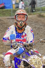 Motocross, Rudersberg, Baden-Württemberg, Germany, Europe, Motocross rider in muddy clothes gives