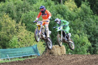 Motocross, Rudersberg, Baden-Württemberg, Germany, Europe, Two motocross riders jump over a ramp in