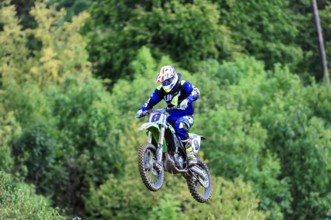 Motocross, Rudersberg, Baden-Württemberg, Germany, Europe, A motocross rider lifts off the ground