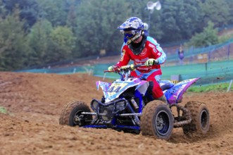 Motocross, Rudersberg, Baden-Württemberg, Germany, Europe, Quad rider in red outfit on a muddy race