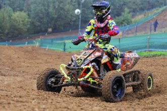 Motocross, Rudersberg, Baden-Württemberg, Germany, Europe, Colourful quad bike rider rides through