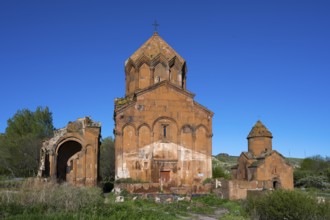 Historic brick church under a clear sky, surrounded by vegetation, cross-domed church, Marmashen