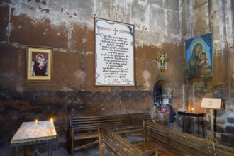Church room with religious art, written work, candlelight, Marmashen Monastery, Marmashen Vank,