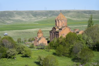 Historic church in the middle of a green landscape with hills and clear skies, Marmashen Monastery,