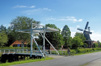 East Frisian bascule bridge, cyclist, gallery bridge, Großefehn, East Frisia, Germany, Lower