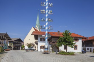Parish Church of the Assumption of the Virgin Mary with maypole and town hall on the village
