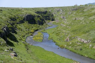 A river meanders through a green gorge under a blue sky, Achuryan River, Akhuryan, near Jradzor,
