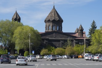 A black church with old architecture and parked cars in a green setting, Cathedral of the Holy