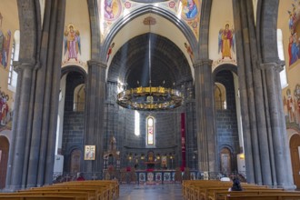 Magnificent church interior with stained glass windows, works of art and a radiant altar area,