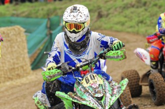 Motocross, Rudersberg, Baden-Württemberg, Germany, Europe, A heavily soiled quad rider in a blue