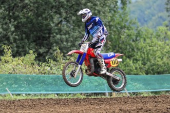 Motocross, Rudersberg, Baden-Württemberg, Germany, Europe, A rider dressed in blue jumps with his