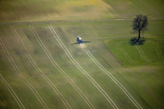 Aerial view, slurry tractor on a field during slurry spraying, emission, in Lichtenfels in Hesse.