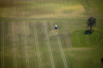 Aerial view, slurry tractor on a field during slurry spraying, emission, in Lichtenfels in Hesse.