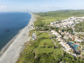 The La Alcaidesa urbanization at the Mediterranean Sea with the Rock of Gibraltar (British) in the