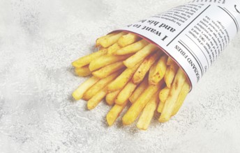 Fried French fries in a paper bag, on an abstract background, without people, in a rustic style, in
