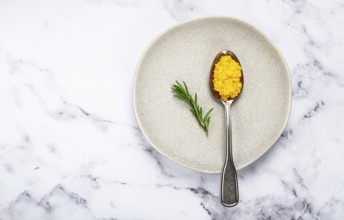 Yuzu caviar is pearly, on a spoon, top view, light background, no people