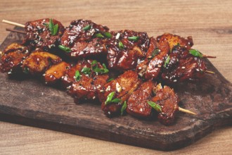 Yakitori chicken kebab, on skewers, with green onions and sesame seeds, top view, without people