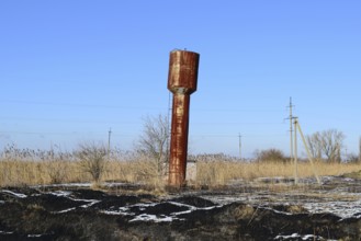 The old rusty water tower tilted. Atyrau, Kazakhstan