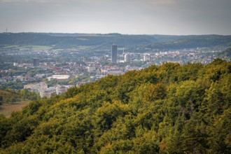 Jena city centre with a striking high-rise building Jentower, surrounded by forests under a grey