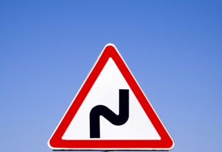 Road sign dangerous turn. Warning a sign. Krasnodar, Russia