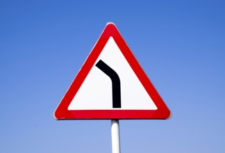 Road sign dangerous turn. Warning a sign. Krasnodar, Russia