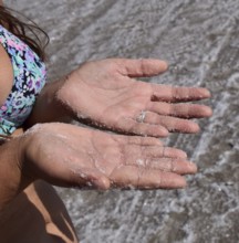 Salt on the girl's hands. Taman, Krasnodar Krai, Russia