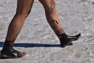 Legs walking girl on the dry bottom of a salt lake. Taman, Krasnodar Krai, Russia