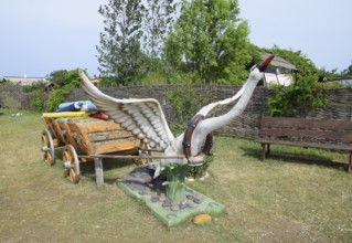 A statue of a swan harnessed to a cart. Taman, Krasnodar Krai, Russia