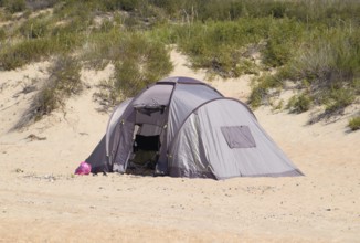 Tourist tent on the sand. Parking of tourists on the sandy beach. Golubitskaya, Russia