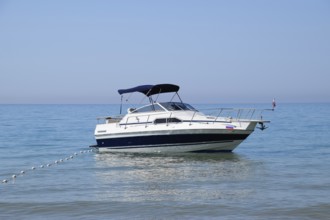 A small boat yacht in the sea near the shore. Golubitskaya, Russia