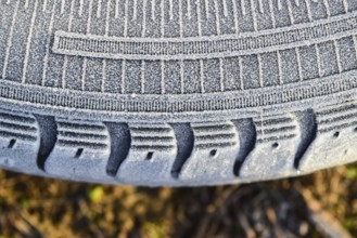 Hoarfrost on a rubber tire wheel. Krasnodar, Russia