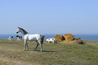 White horse, Figures of horses made of plastic on the lawn. Taman, Krasnodar Krai, Russia