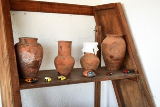 Shelves with standing on their utensils of porcelain and earthenware. Taman, Krasnodar Krai, Russia