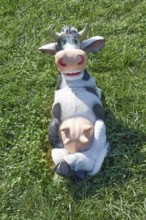Toy cow lying upside udder. Taman, Krasnodar Krai, Russia