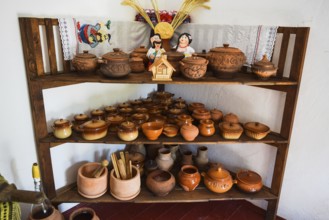Shelves with standing on their utensils of porcelain and earthenware. Taman, Krasnodar Krai, Russia