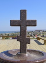 Orthodox cross made of granite near the chapel. Taman, Krasnodar Krai, Russia