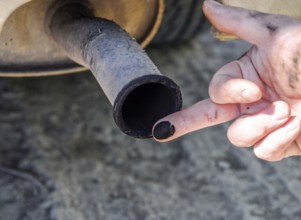Soot from the exhaust pipe on the finger. Atyrau, Kazakhstan