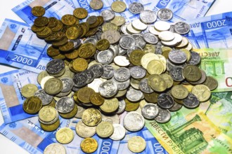 A handful of coins on new Russian banknotes in denominations of 2000 and 200 rubles. Krasnodar,