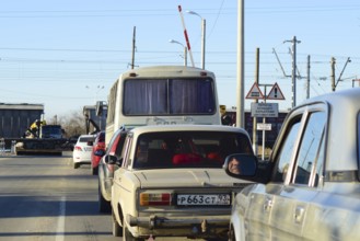 Waiting for passage of a freight train near railway crossing. Krasnodar, Russia