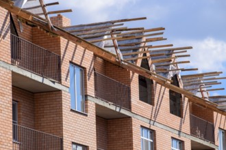 A three-storey brick apartment building under construction. Atyrau, Kazakhstan