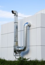 Ventilation hood with a pipe behind the cafe building. Atyrau, Kazakhstan