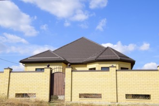 Decorative metal on the roof of a brick house. Atyrau, Kazakhstan