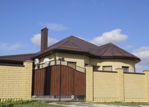 Decorative metal on the roof of a brick house. Atyrau, Kazakhstan