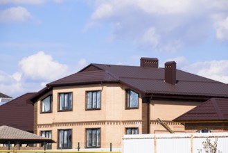 Decorative metal on the roof of a brick house. Atyrau, Kazakhstan