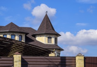 Decorative metal on the roof of a brick house. Atyrau, Kazakhstan