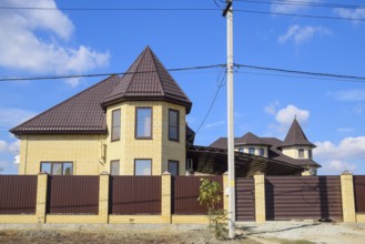 Decorative metal on the roof of a brick house. Atyrau, Kazakhstan