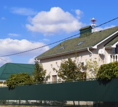 Asphalt shingle. Decorative bitumen shingles on the roof of a brick house. Atyrau, Kazakhstan