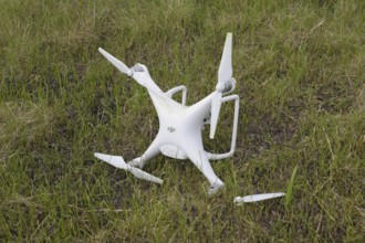 The crashed drone. Dirty and in the juice of the grass is a quadrocopter. Atyrau, Kazakhstan