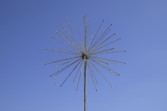 Street lamp in the form of fireworks. Garlands on a steel frame in the shape of a ball fireworks.